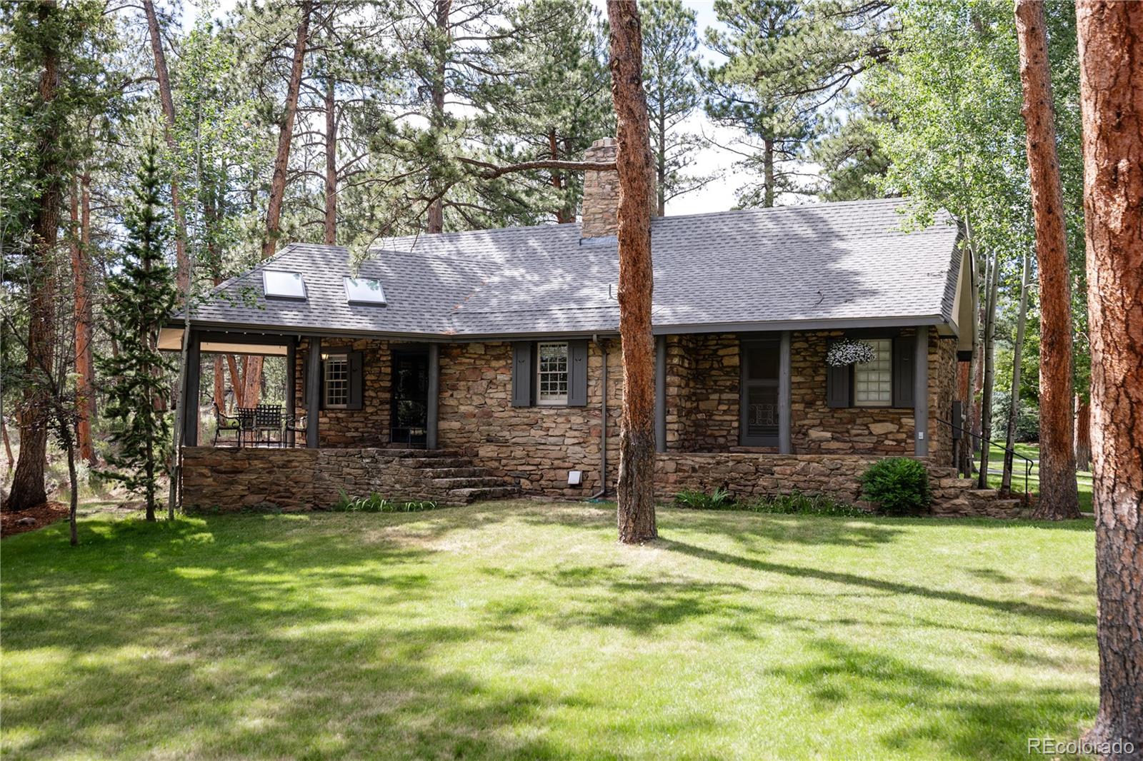 222 Greystone Road Evergreen, CO 80439 - Photo 12 of 31 a front view of a house with garden