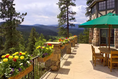 a view of a patio with table and chairs potted plants