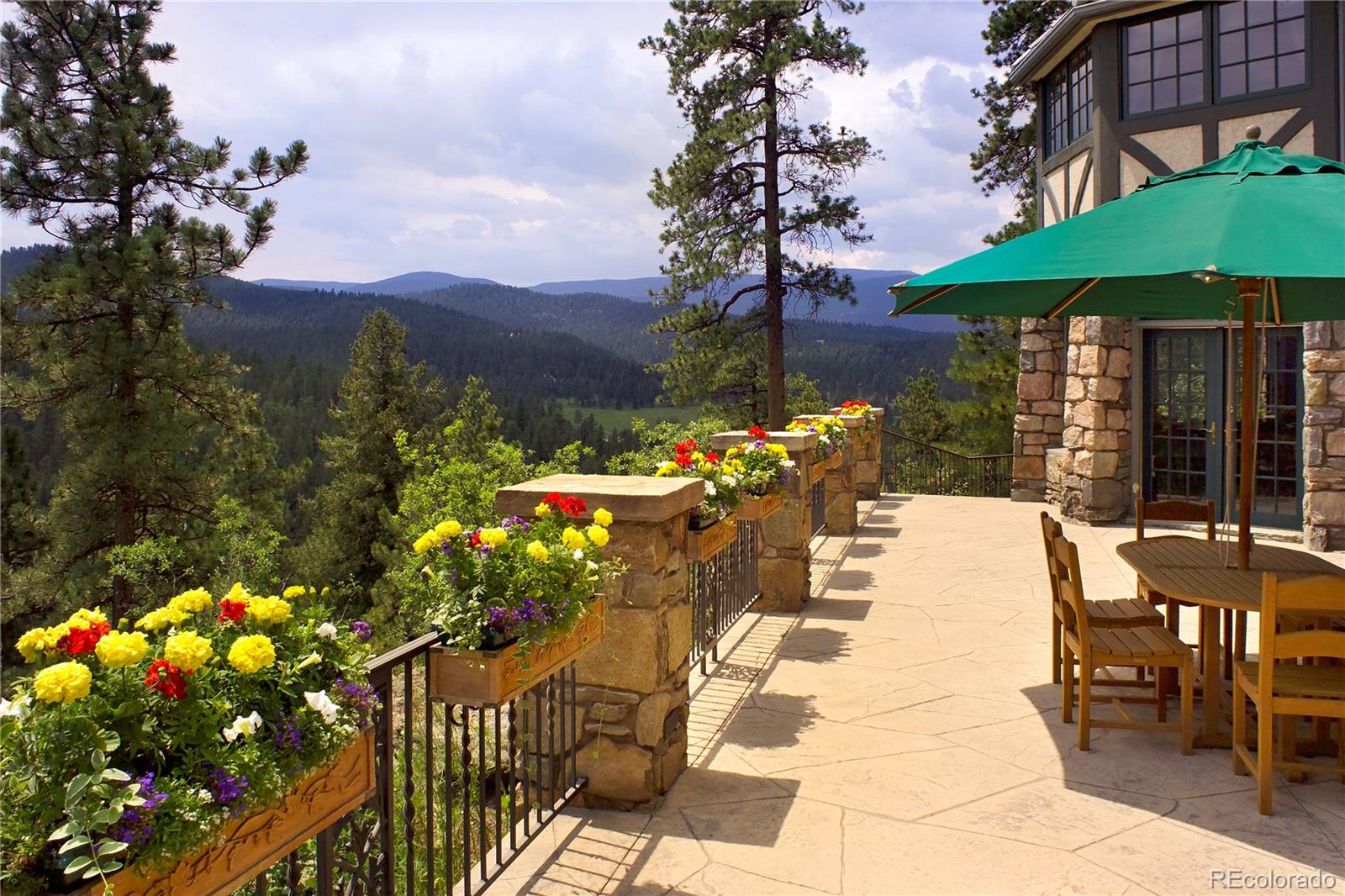 222 Greystone Road Evergreen, CO 80439 - Photo 5 of 31 a view of a patio with table and chairs potted plants