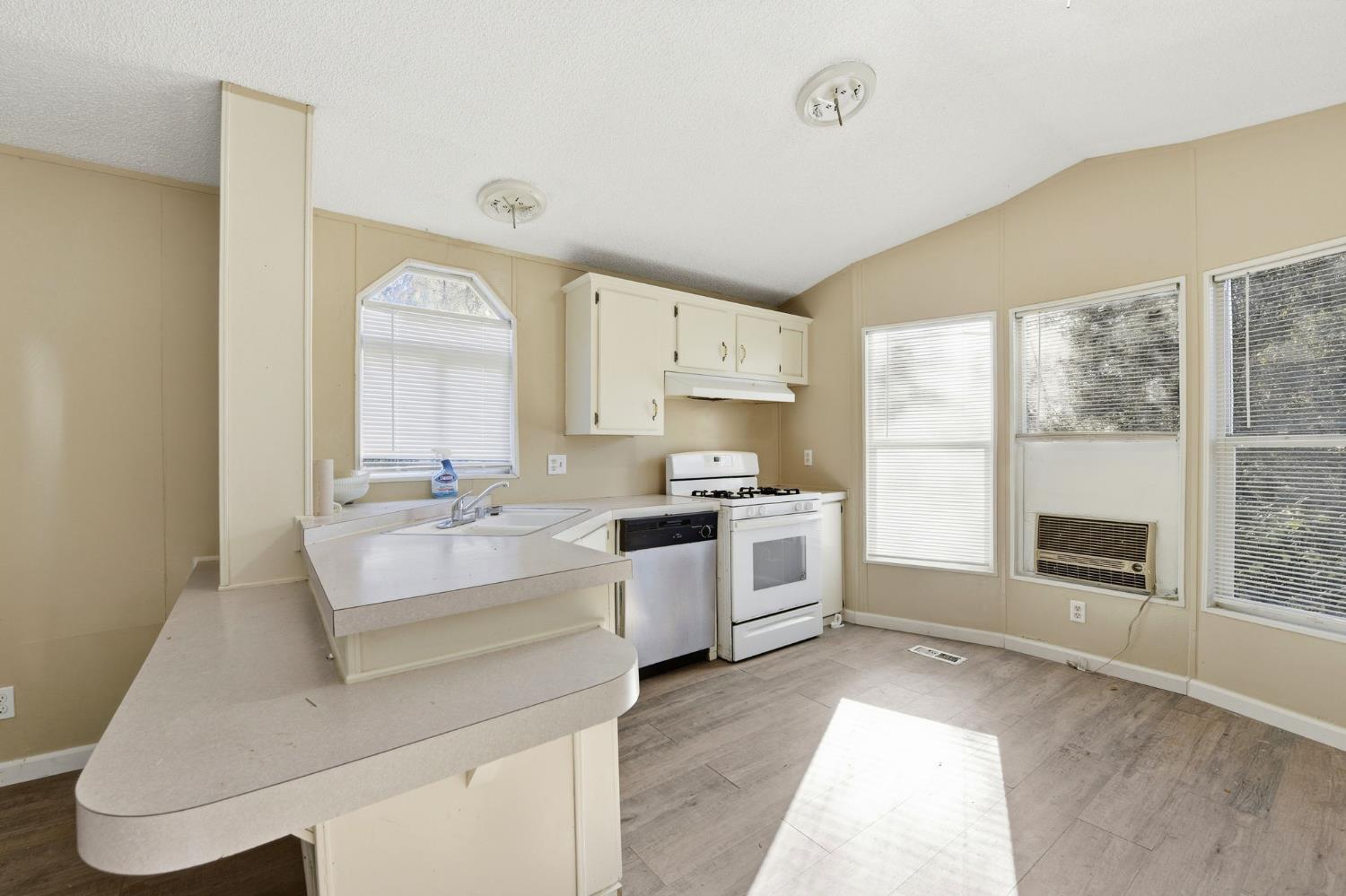 1160 Pleasant Valley Road Diamond Springs, CA 95619 - Photo 25 of 42 a large white open kitchen with a large window