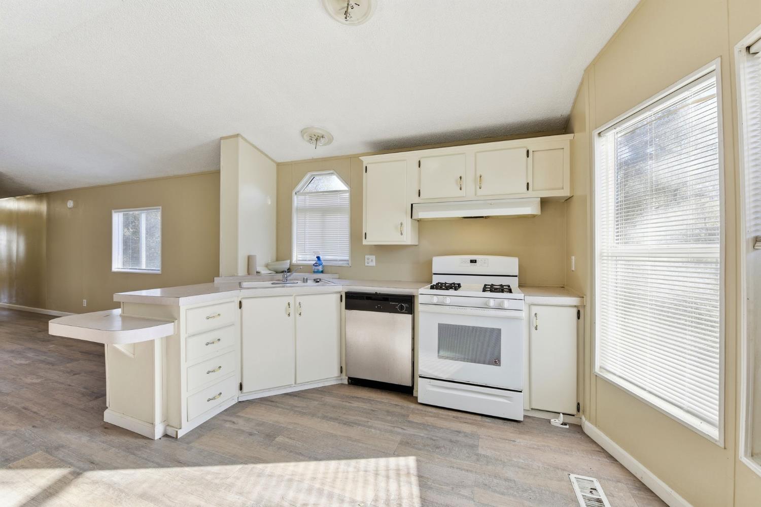 1160 Pleasant Valley Road Diamond Springs, CA 95619 - Photo 27 of 42 a kitchen with stainless steel appliances granite countertop a stove a sink and a refrigerator