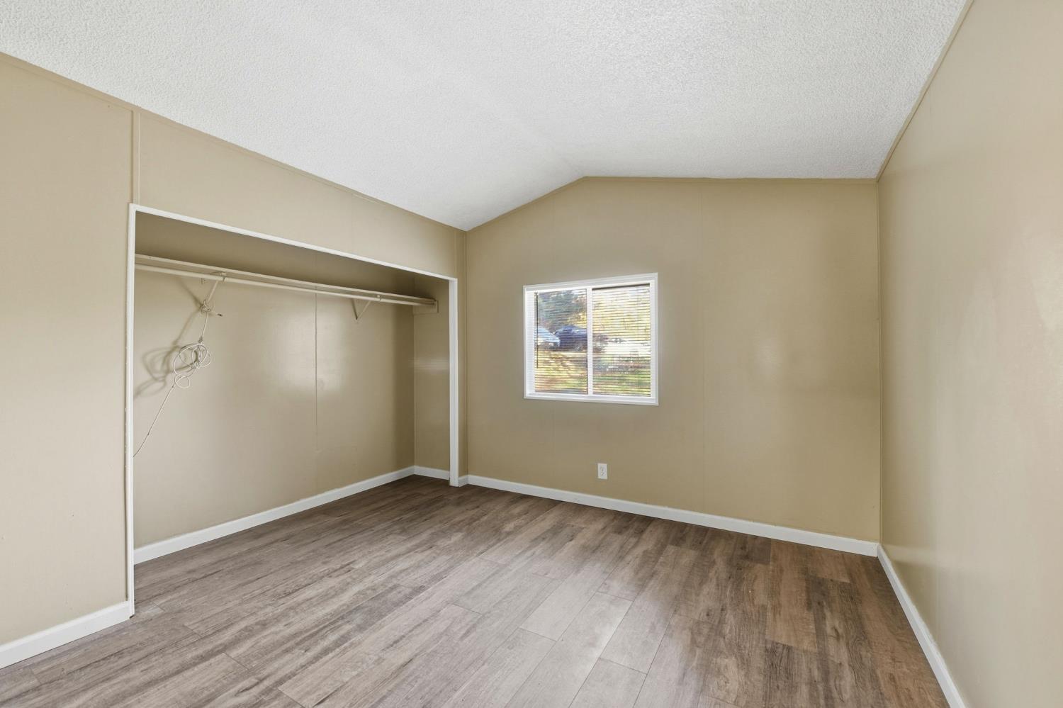 1160 Pleasant Valley Road Diamond Springs, CA 95619 - Photo 31 of 42 an empty room with wooden floor and windows