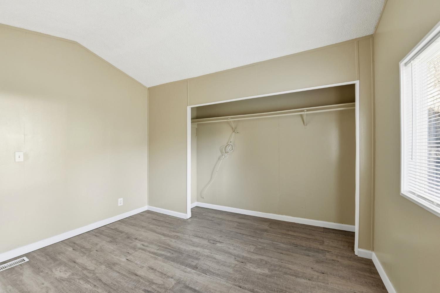 1160 Pleasant Valley Road Diamond Springs, CA 95619 - Photo 32 of 42 an empty room with wooden floor and windows
