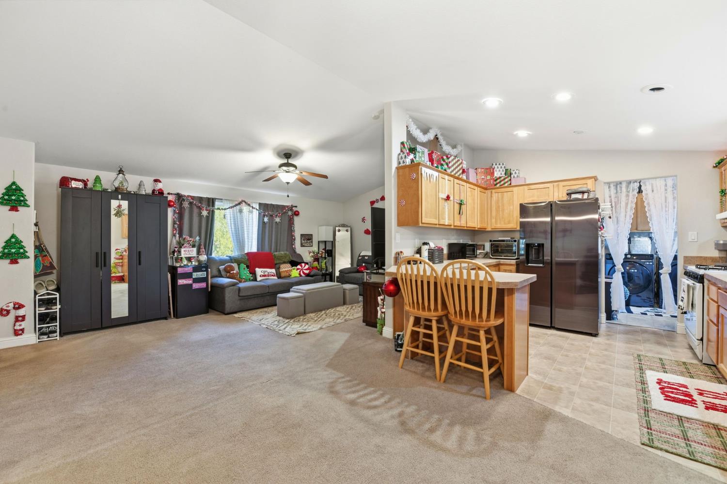 1160 Pleasant Valley Road Diamond Springs, CA 95619 - Photo 8 of 42 a living room with furniture a flat screen tv and a large window