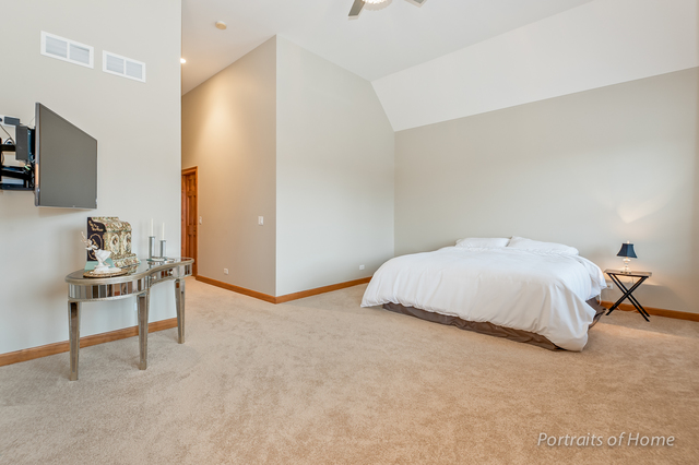 1015 Mackenzie Place Wheaton, IL 60187 - Photo 14 of 26 a bedroom with a bed and a chair in it