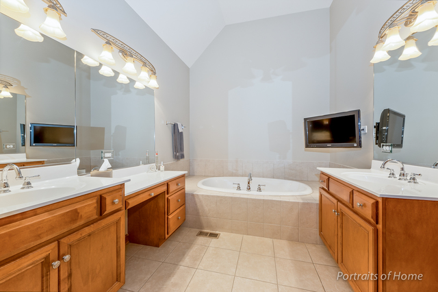 1015 Mackenzie Place Wheaton, IL 60187 - Photo 15 of 26 a spacious bathroom with a sink double vanity mirror and bathtub