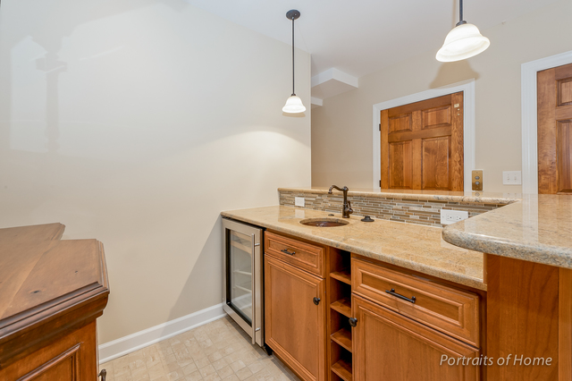 1015 Mackenzie Place Wheaton, IL 60187 - Photo 20 of 26 a bathroom with a sink and a mirror