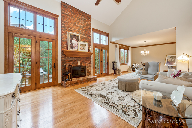 1015 Mackenzie Place Wheaton, IL 60187 - Photo 3 of 26 a living room with fireplace furniture and a large window
