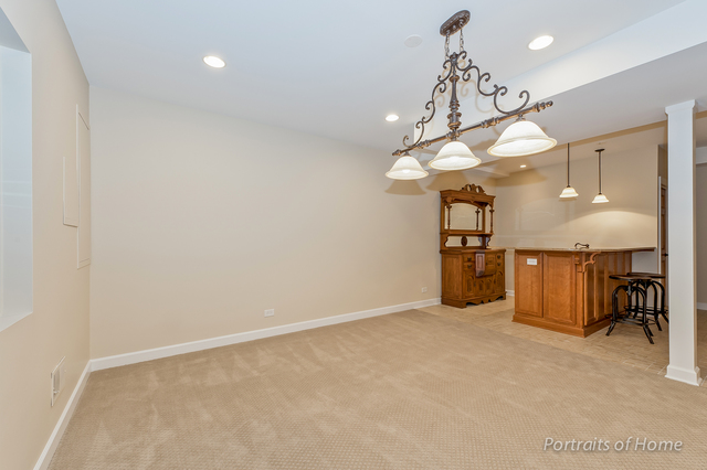 1015 Mackenzie Place Wheaton, IL 60187 - Photo 22 of 26 a view of a kitchen with a sink and a refrigerator