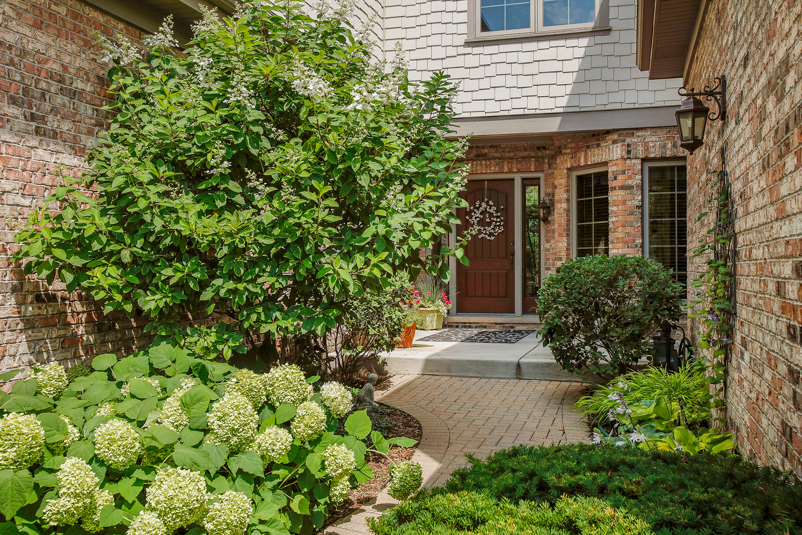1015 Mackenzie Place Wheaton, IL 60187 - Photo 25 of 26 a front view of a house with a yard and a garden