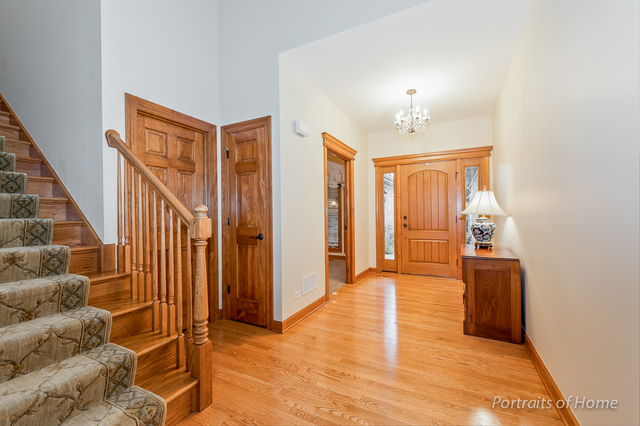 1015 Mackenzie Place Wheaton, IL 60187 - Photo 10 of 26 wooden floor in an empty room with a window