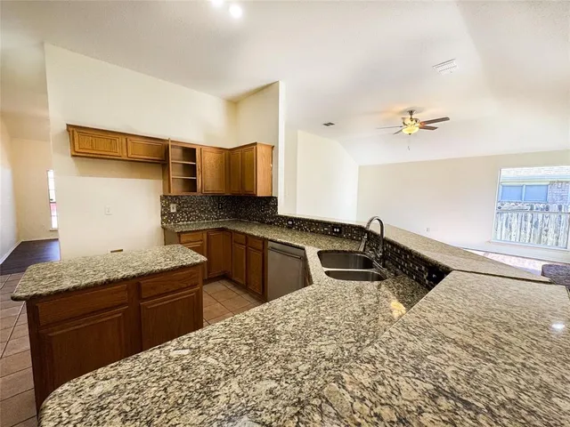 a kitchen with a stove a sink and a refrigerator