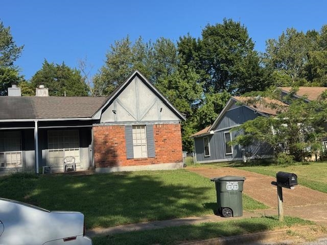 2205 Oldfield Drive Memphis, TN 38134 - Photo 2 of 4 a front view of a house with garden