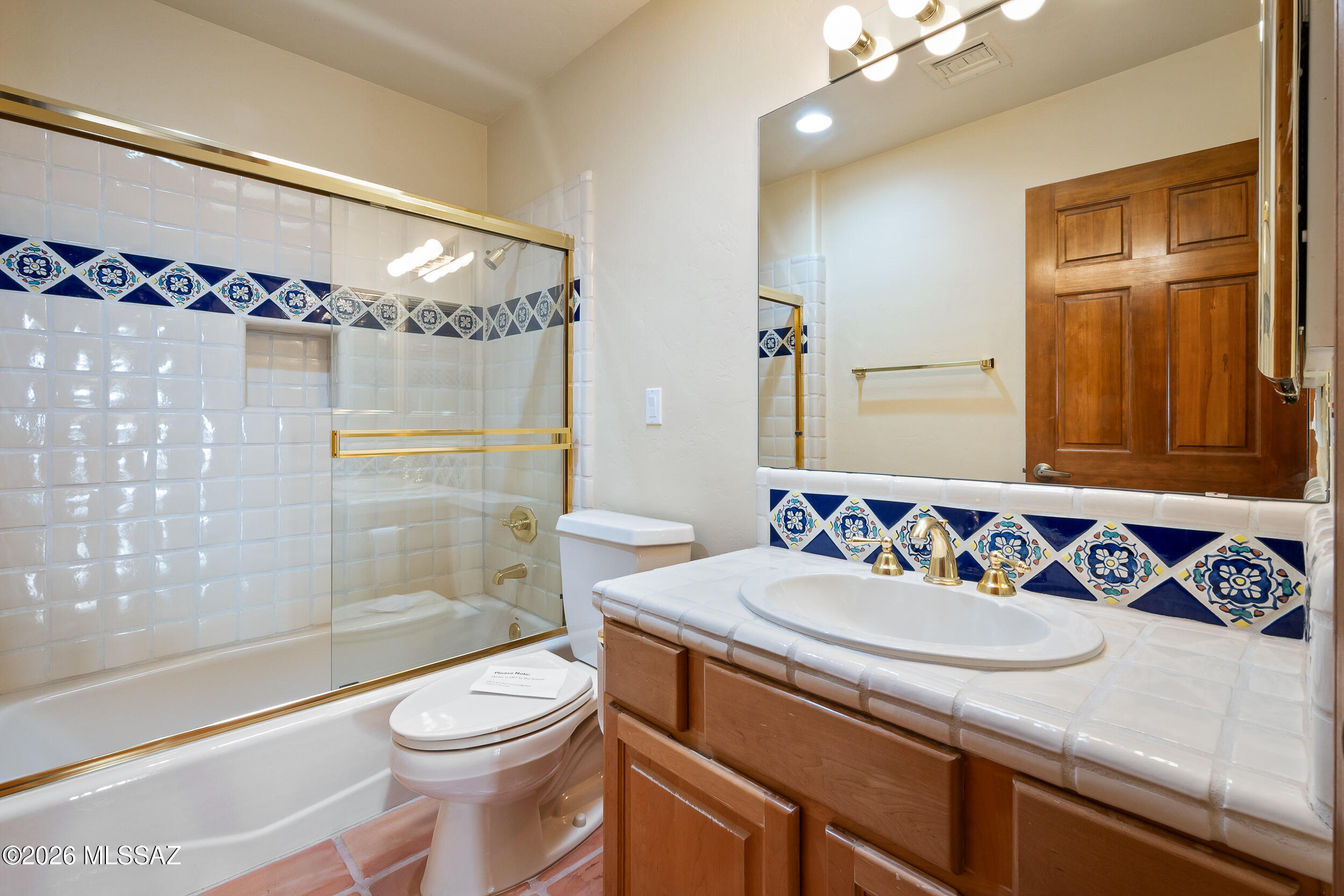 13630 East Sahuaro Sunset Road Tucson, AZ 85749 - Photo 14 of 47 a bathroom with a sink a toilet and shower