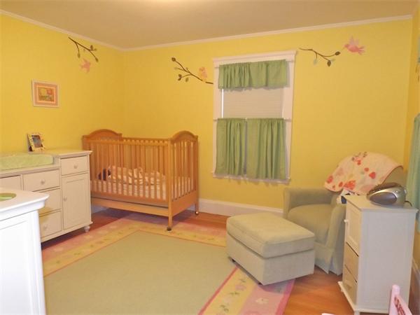 35 Ellison Road Newton, MA 02459 - Photo 12 of 22 a living room with a baby crib furniture and a wooden floor