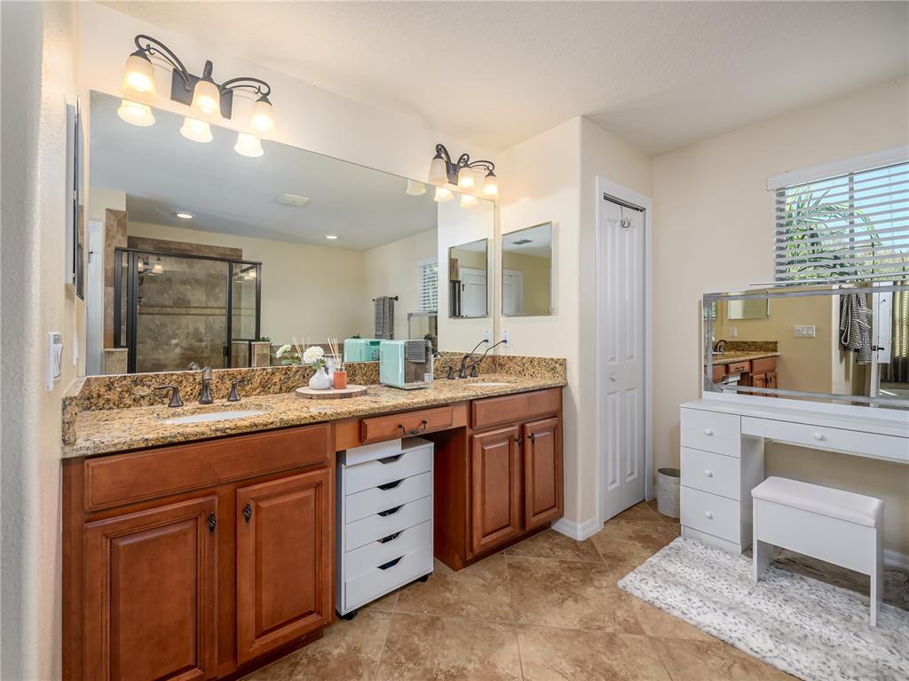 20213 Regal Fern Court Tampa, FL 33647 - Photo 26 of 65 a bathroom with a granite countertop sink and a mirror