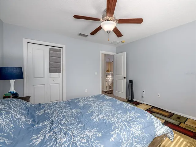 a bathroom with a granite countertop sink toilet and mirror