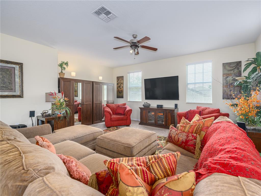 20213 Regal Fern Court Tampa, FL 33647 - Photo 39 of 65 a living room with furniture and a flat screen tv