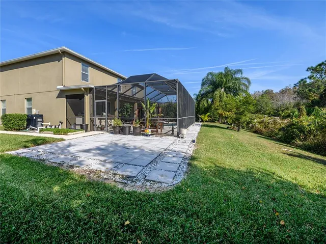 an aerial view of a house with a yard swimming pool and outdoor seating