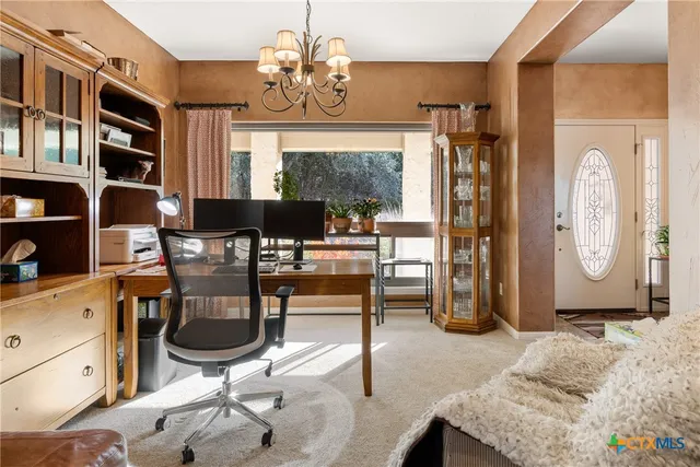 a view of a livingroom with furniture and window