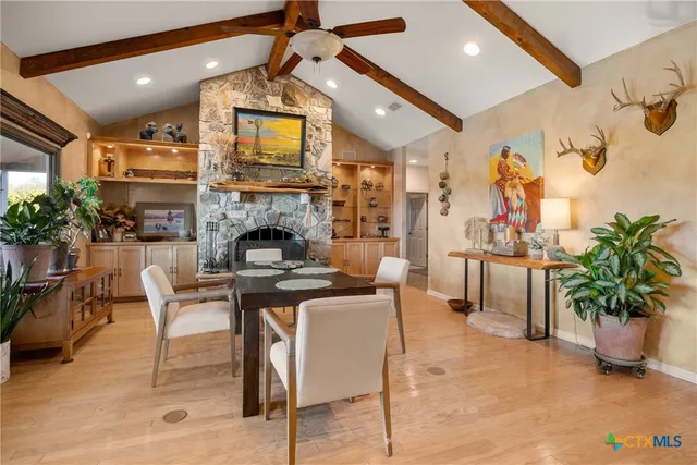 a living room with furniture a fireplace and potted plants