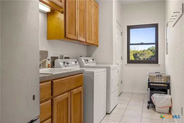a utility room with a sink washer and dryer