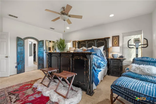 a bedroom with furniture and a chandelier