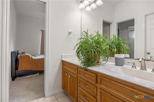 a bathroom with a sink and mirror