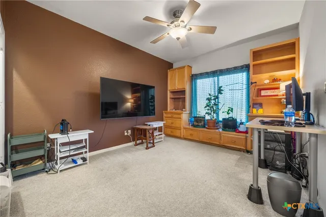 a view of a livingroom with furniture and a flat screen tv