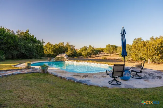 a view of a lake with a yard and sitting area