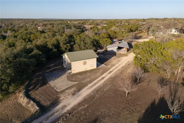 an aerial view of a house with a yard