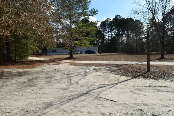 a backyard of a house with lots of trees