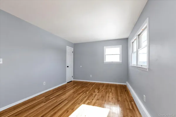 a view of a room with wooden floor and window