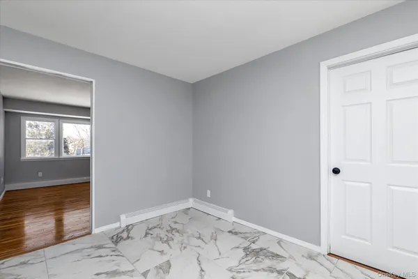 a view of a big room with wooden floor and closet