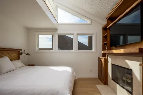 a bedroom with a bed and a flat screen tv