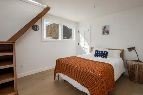 a bedroom with a bed and cabinets