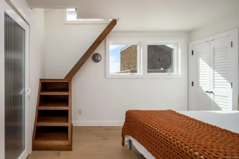 a bedroom with a bed and a window