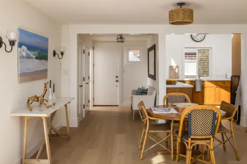 a view of a dining room with furniture and a chandelier