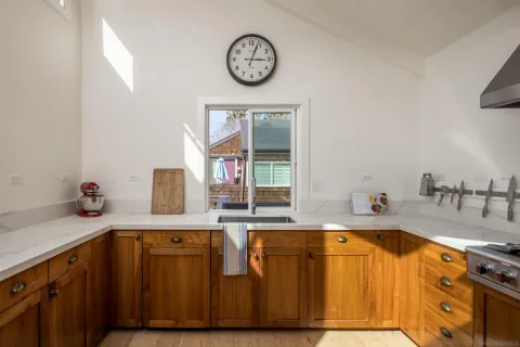 a bathroom with a granite countertop sink and a large mirror