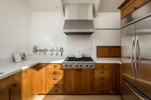 a kitchen with stainless steel appliances granite countertop a stove and a refrigerator