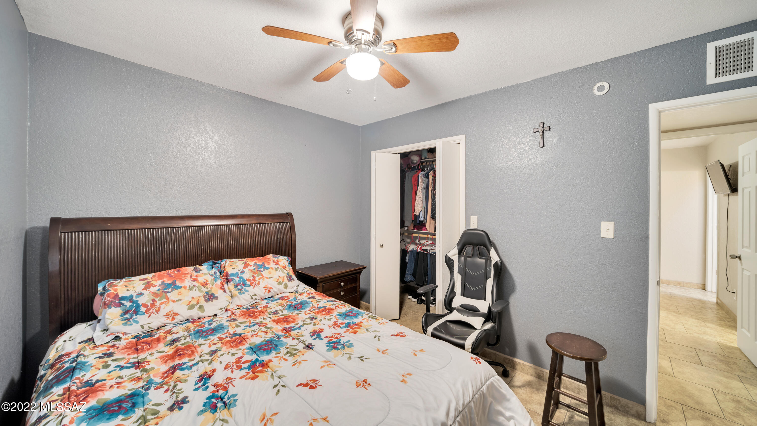 434 Paseo Flamenco Rio Rico, AZ 85648 - Photo 16 of 27 a bedroom with a bed and a chandelier