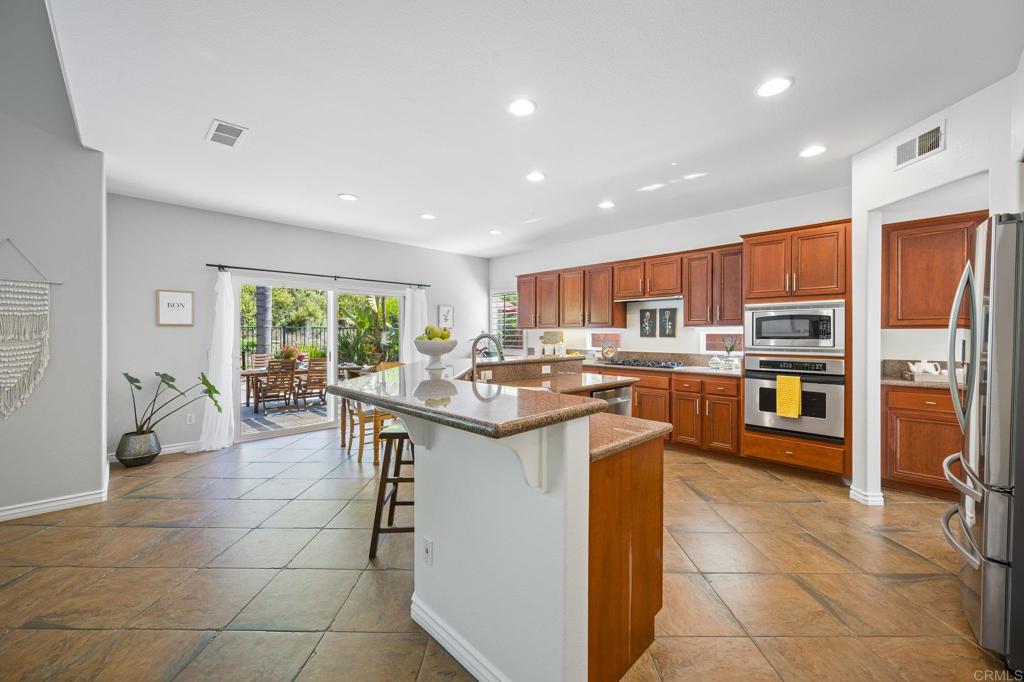 2107 Sun Valley Road San Marcos, CA 92078 - Photo 12 of 41 a kitchen with stainless steel appliances granite countertop a sink and a refrigerator
