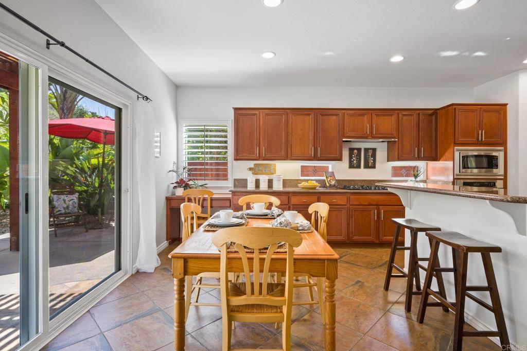 2107 Sun Valley Road San Marcos, CA 92078 - Photo 14 of 41 a dinning room with stainless steel appliances granite countertop a dining table chairs refrigerator and kitchen view