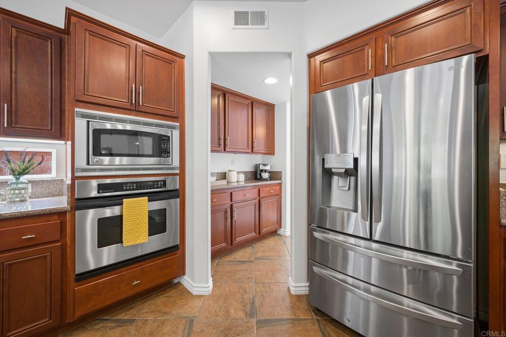 2107 Sun Valley Road San Marcos, CA 92078 - Photo 16 of 41 a kitchen with stainless steel appliances granite countertop a refrigerator microwave and stove