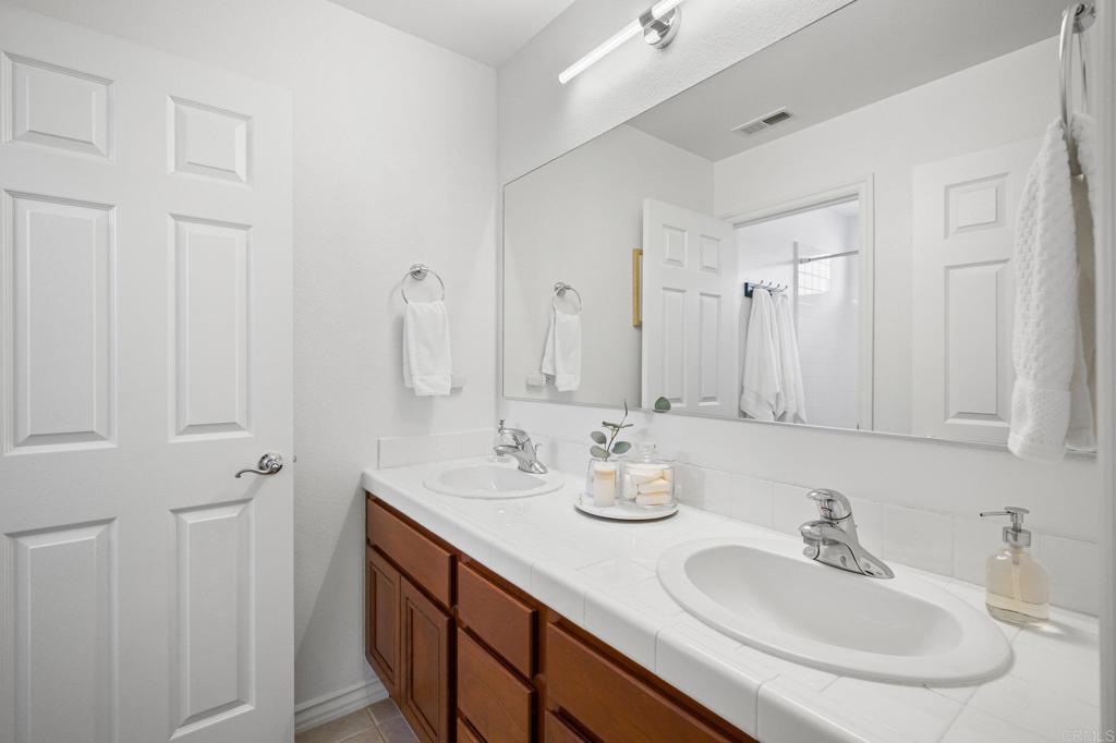 2107 Sun Valley Road San Marcos, CA 92078 - Photo 29 of 41 a bathroom with double vanity sinks and a mirror