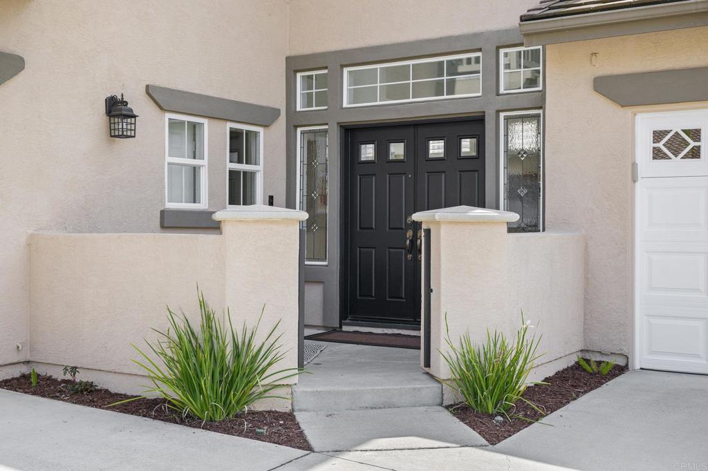 2107 Sun Valley Road San Marcos, CA 92078 - Photo 3 of 41 a white house with a potted plant and a windows
