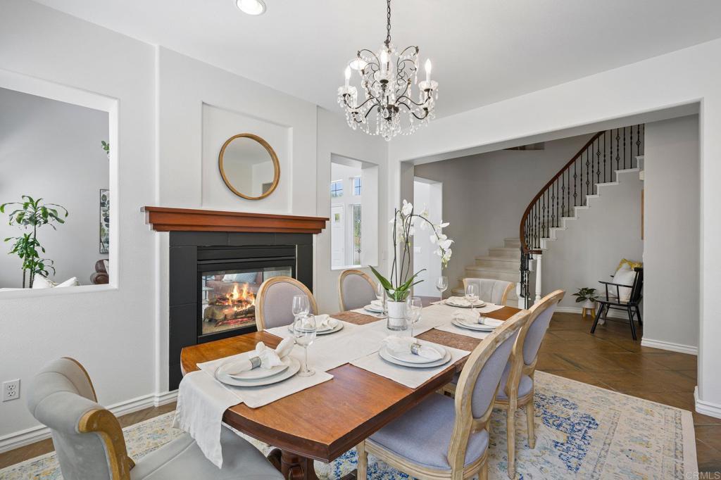2107 Sun Valley Road San Marcos, CA 92078 - Photo 8 of 41 a view of a dining room with furniture a chandelier and wooden floor