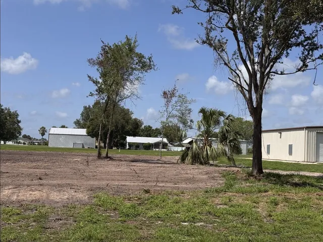 a backyard of a house with a yard and outdoor seating