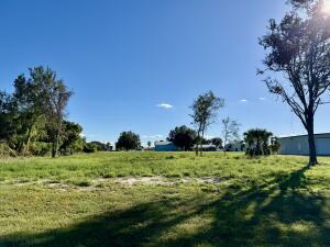 14082 Southwest 16th Court Okeechobee, FL 34974 - Photo 6 of 6 a backyard of a house with a yard and outdoor seating
