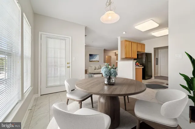 a view of a dining room with furniture and a potted plant